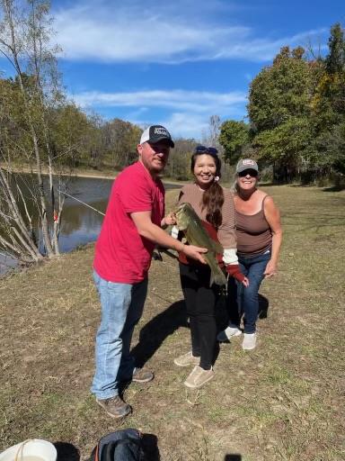 A group of people holding a fish