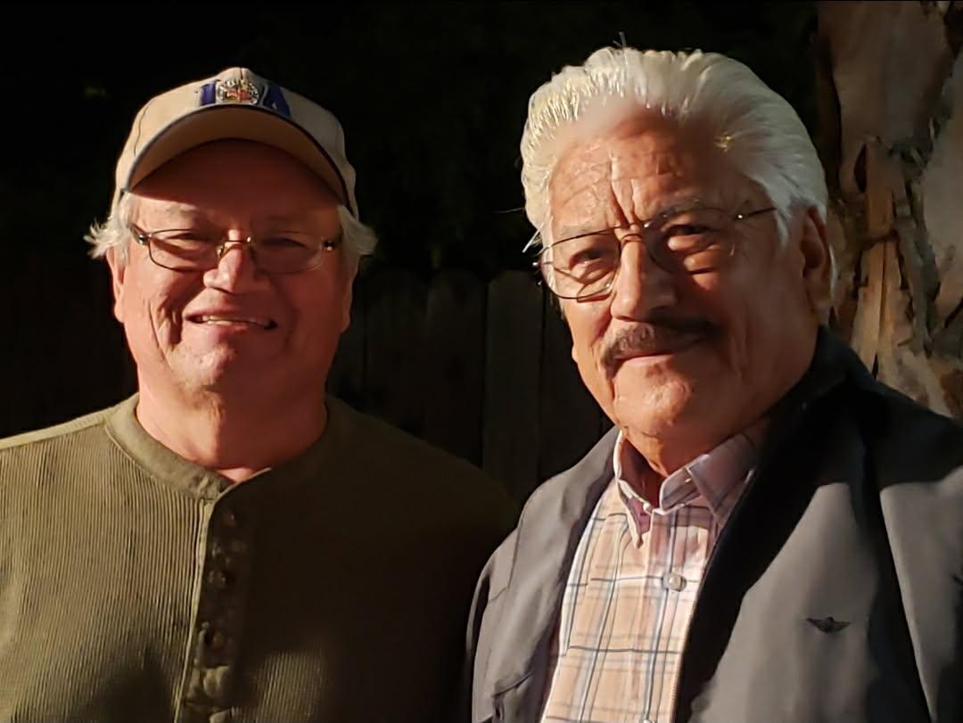 Two men smiling at the camera