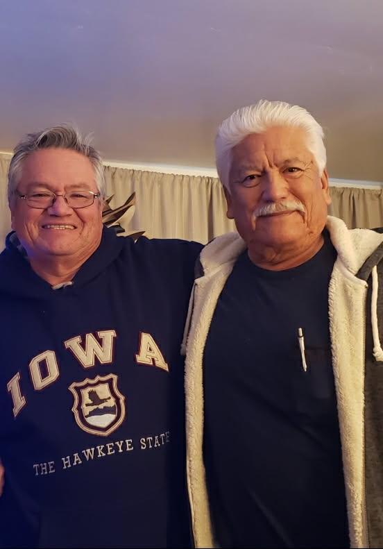 Two men standing together smiling