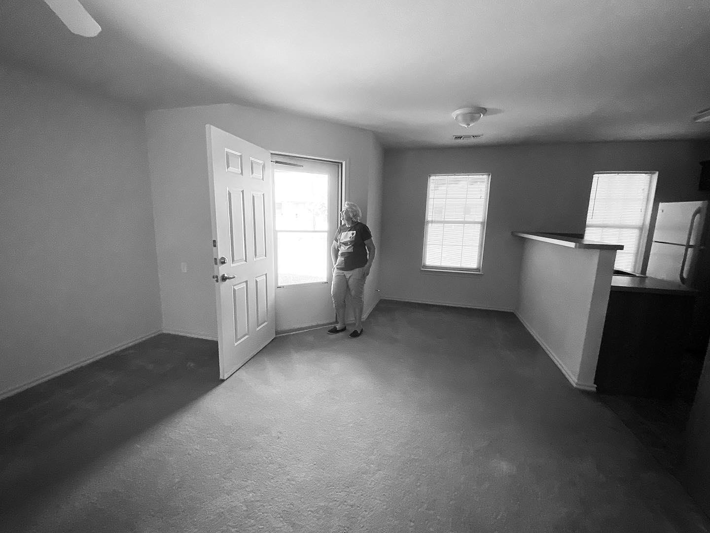 A woman standing in a room with a door