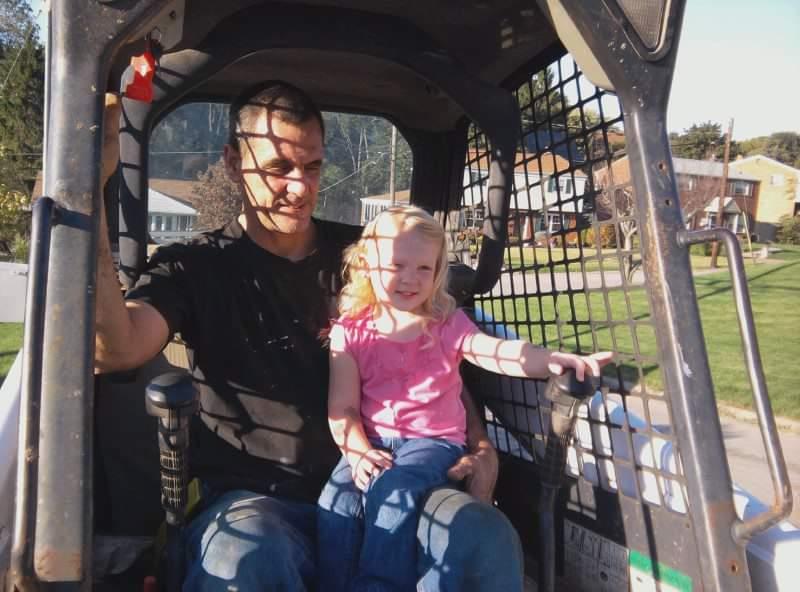 A man and child in a tractor