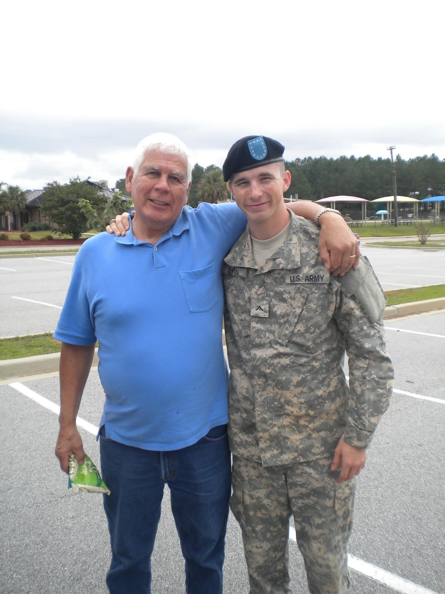 A man in military uniform with a man in a parking lot