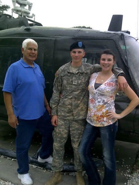 A group of people standing in front of a vehicle