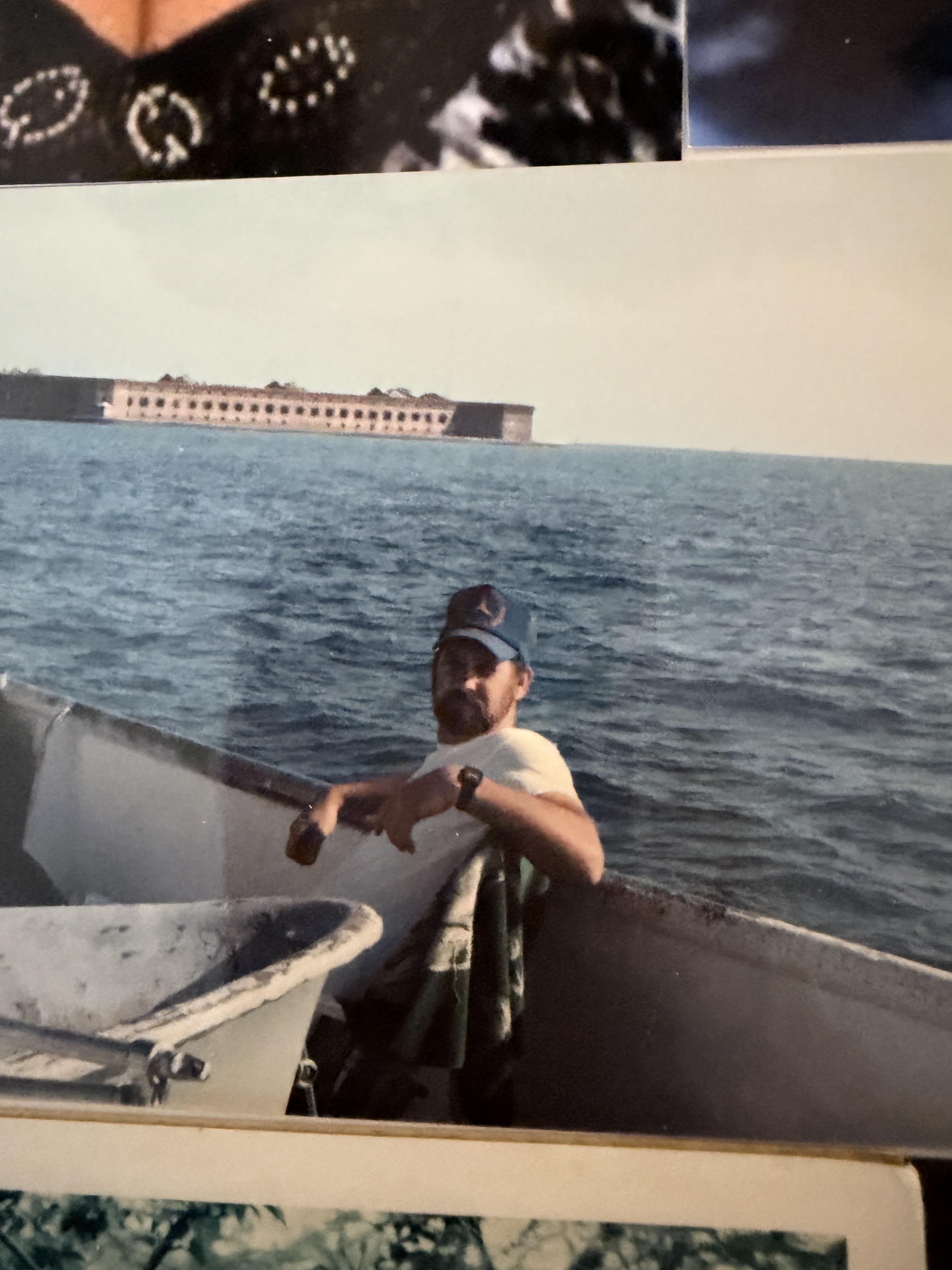 A man leaning on a boat