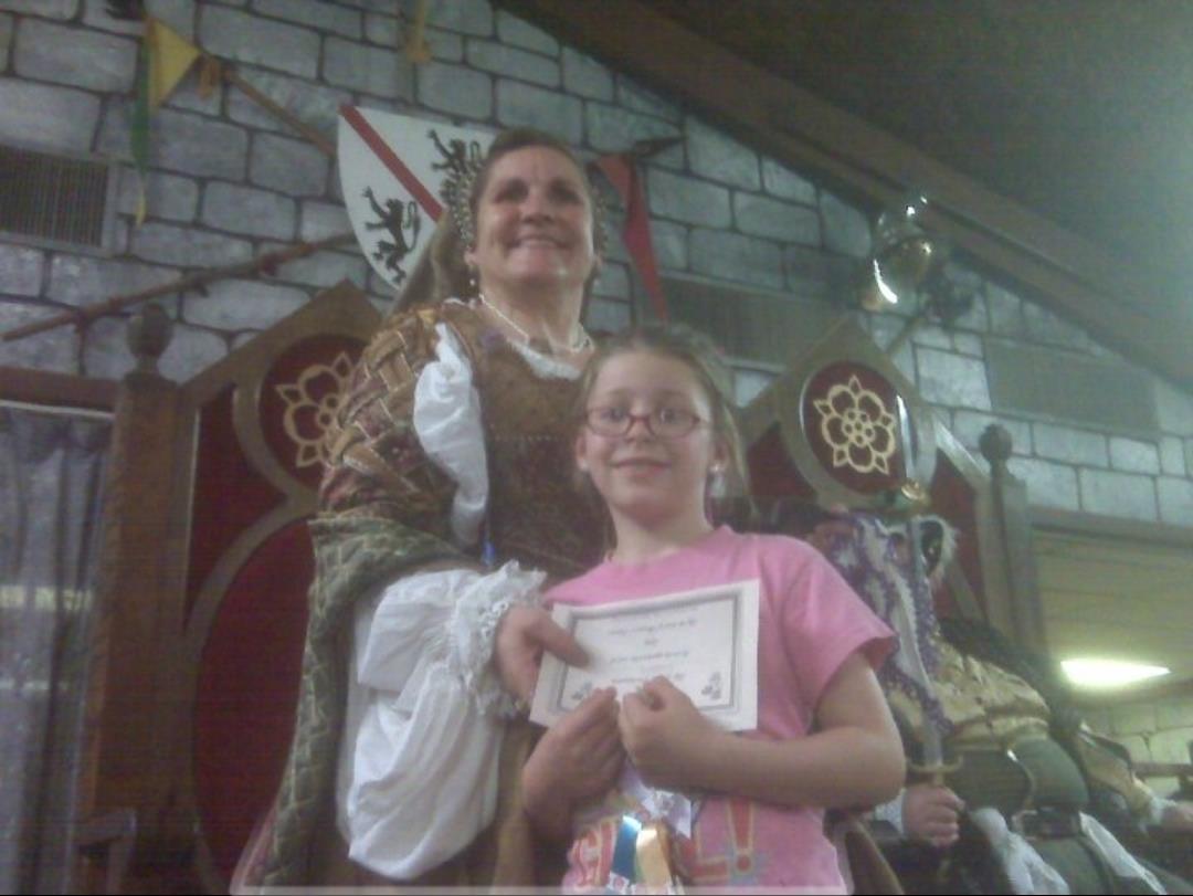 A woman and a girl posing for a picture