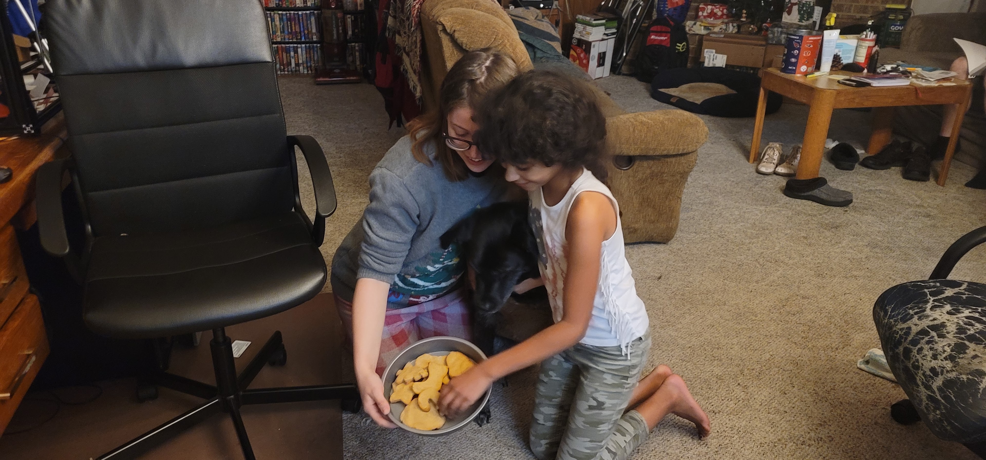 Two people feeding a dog