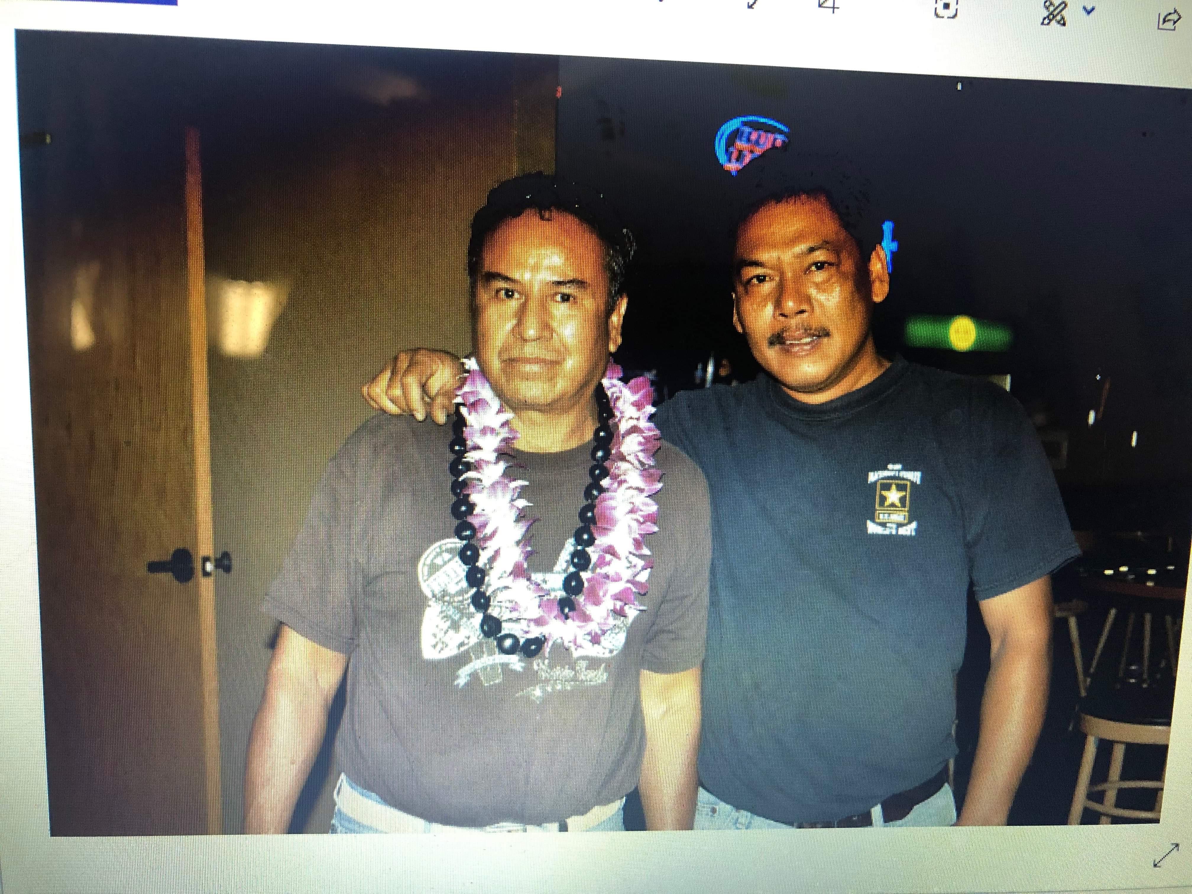 A man posing with a lei