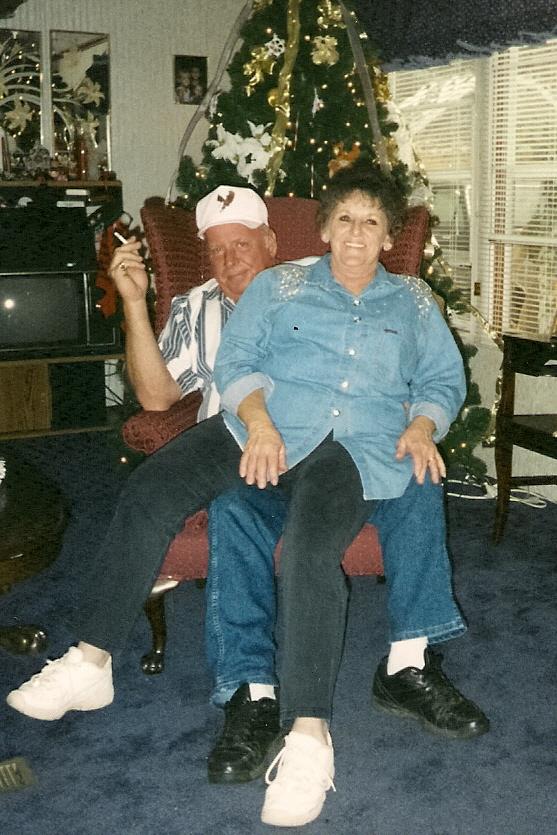 A man and woman sitting in a chair