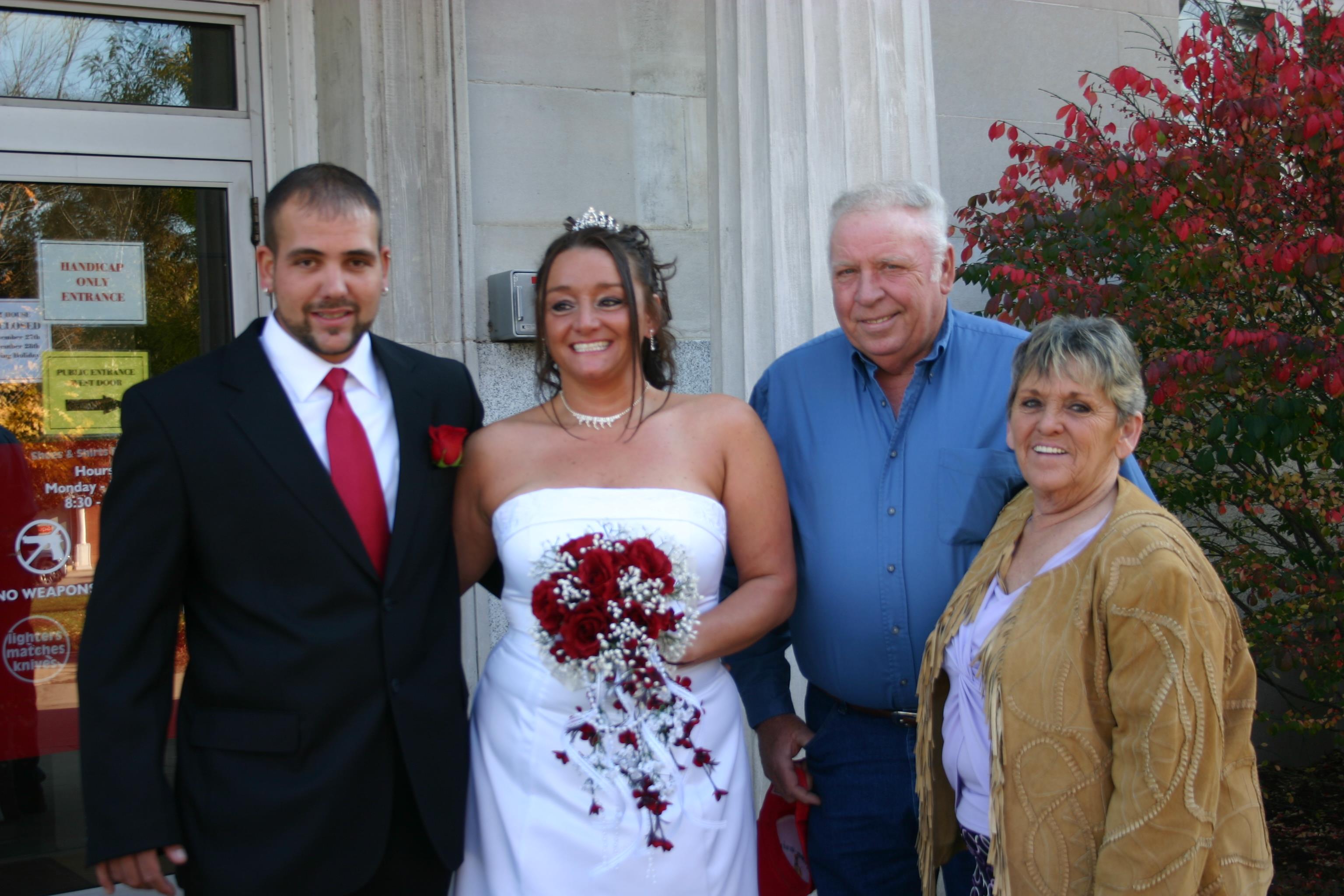 A bride and groom posing for a photo