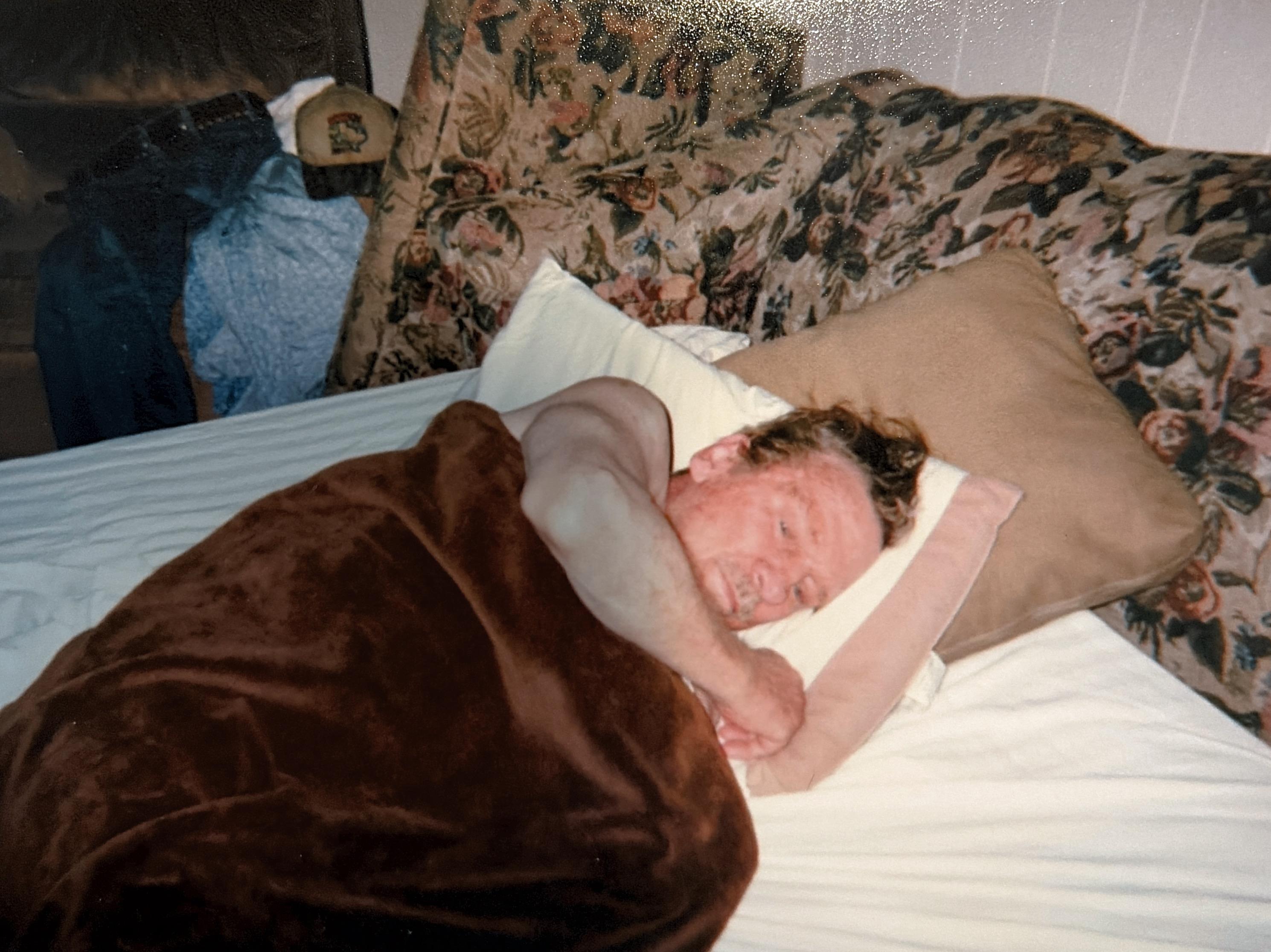 A man sleeping in a bed
