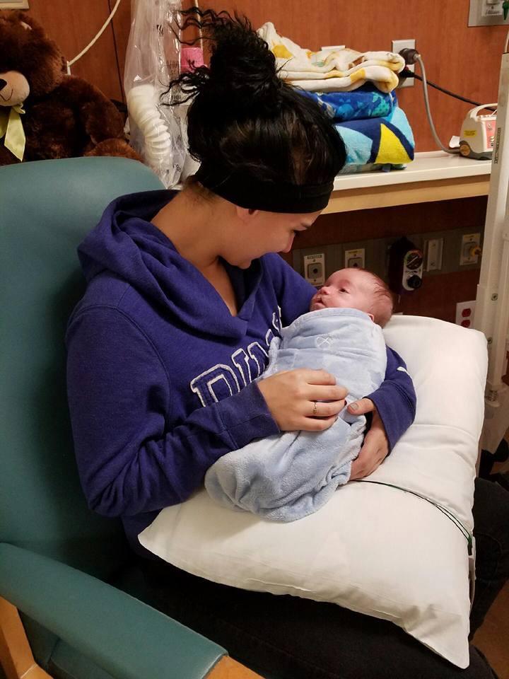 A woman holding a baby