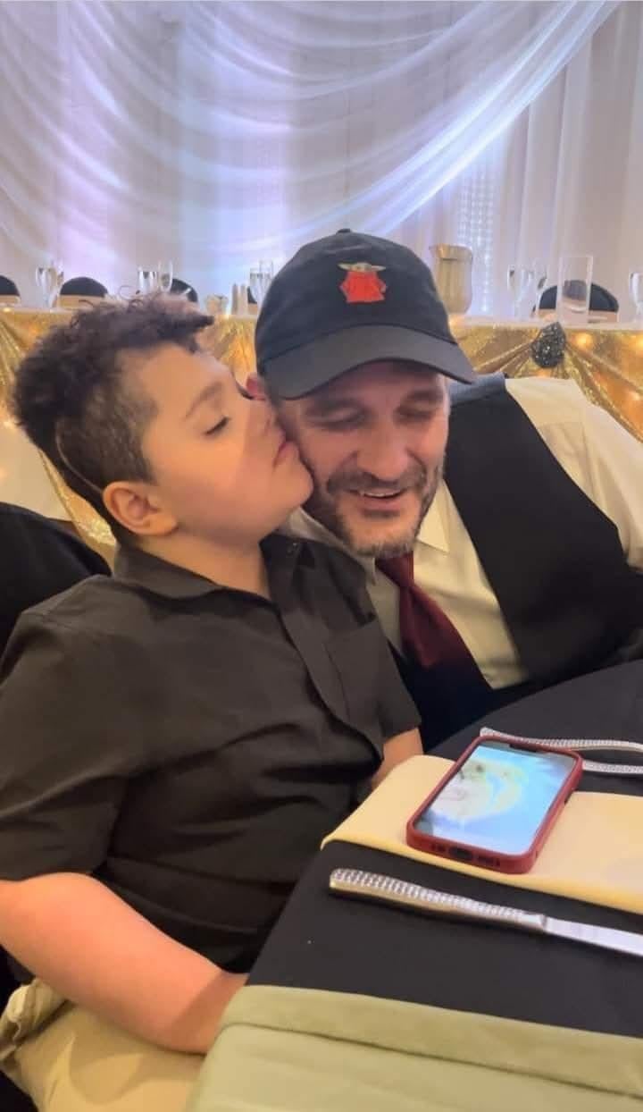 A man and boy sitting at a table