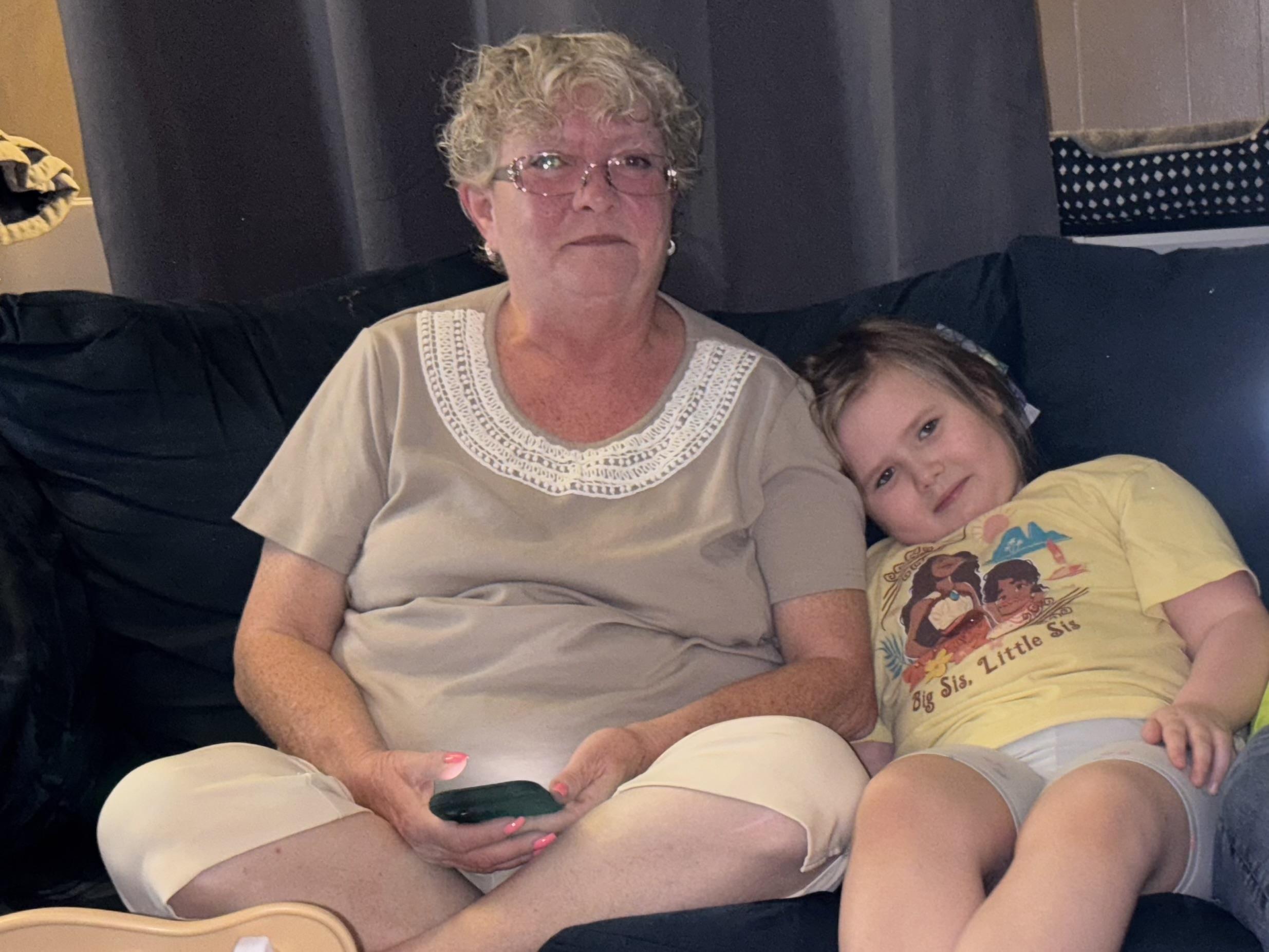 A woman and a child sitting on a couch