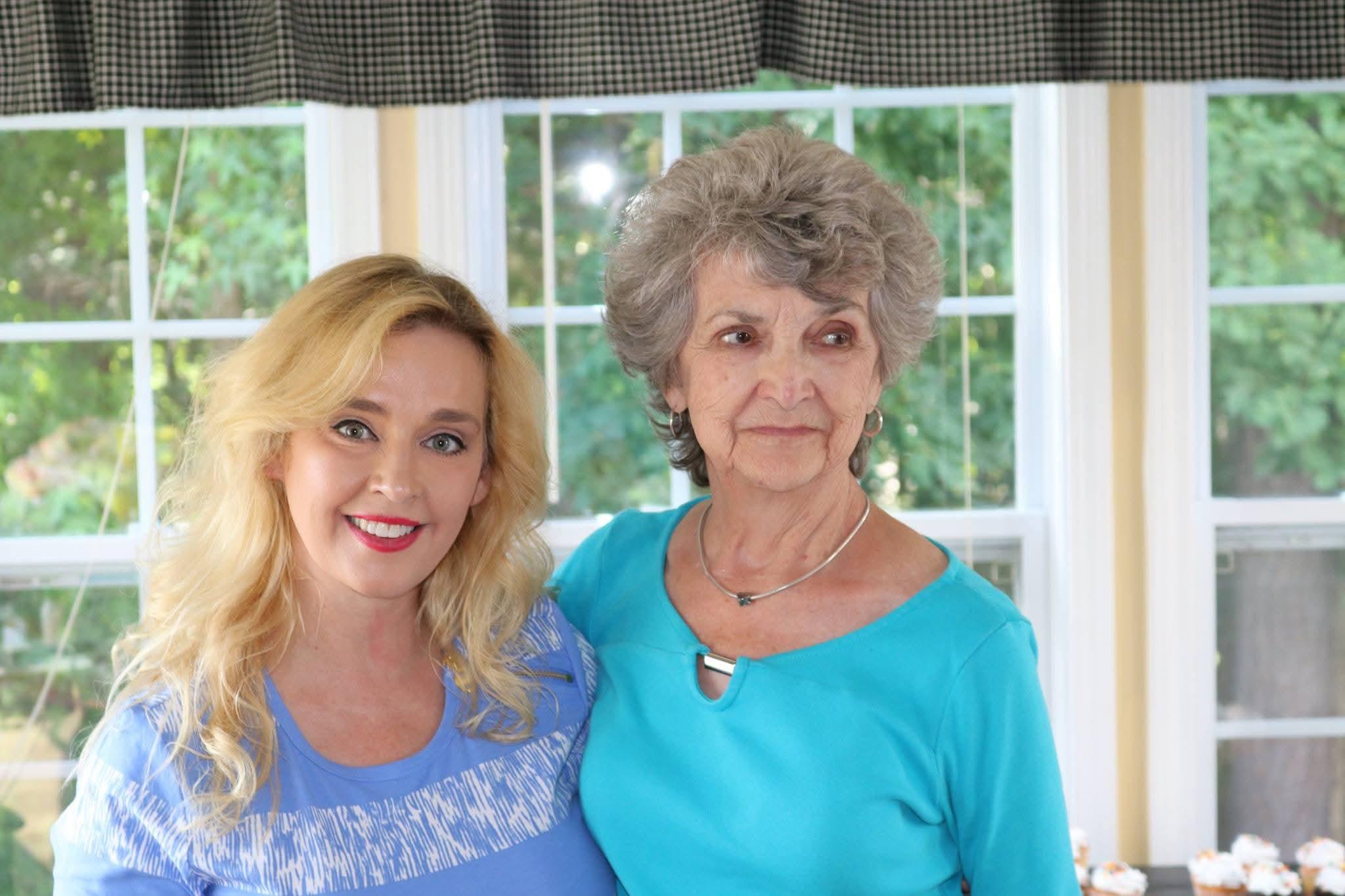 A woman and a woman posing for a picture