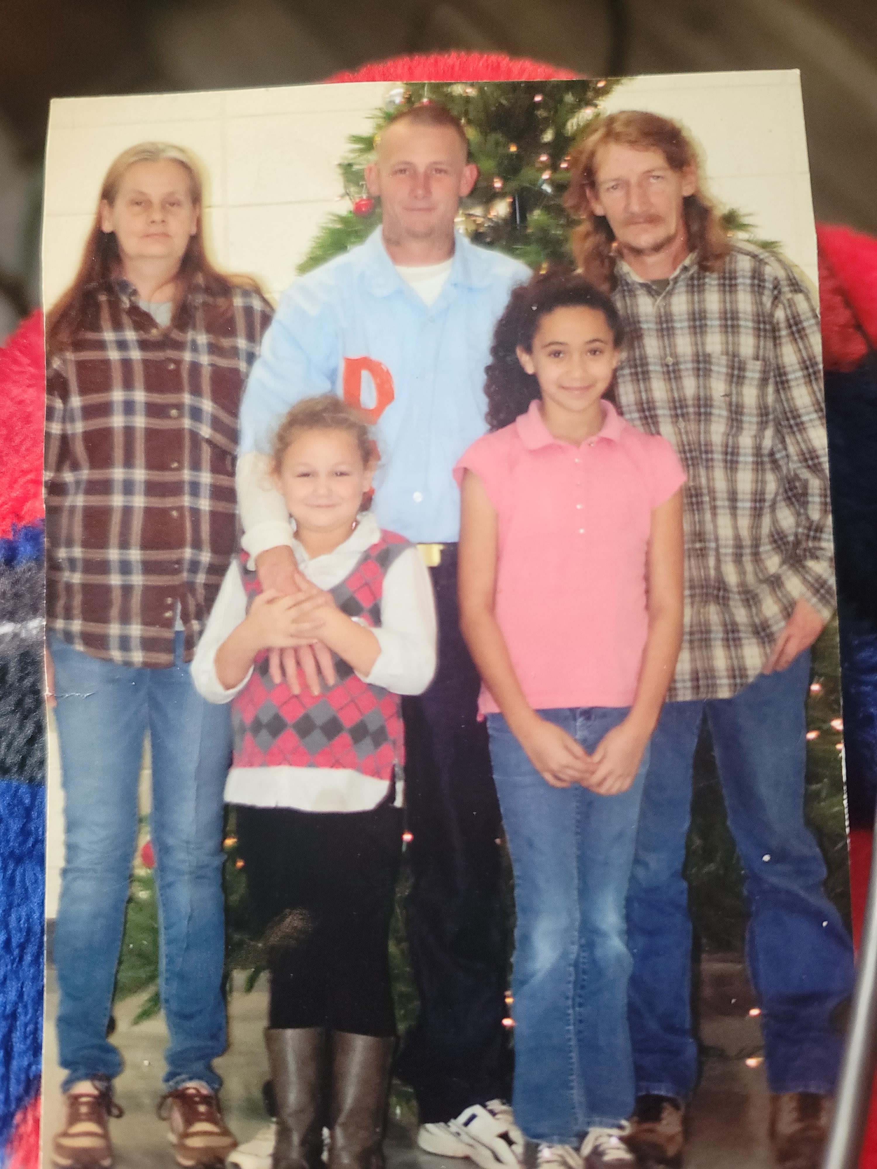 A family photo of a man and a woman and a girl