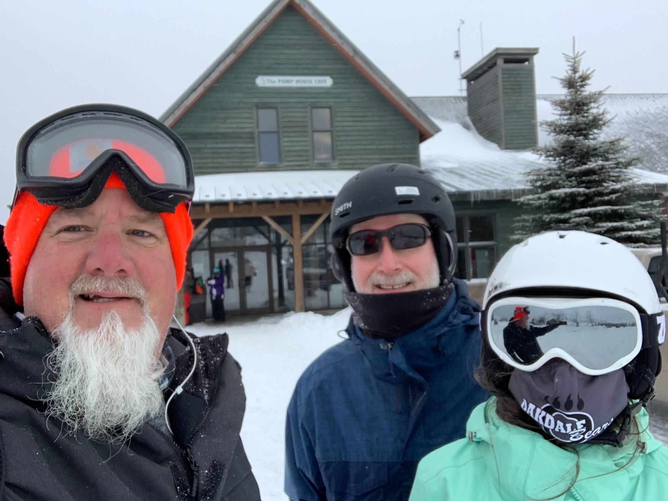 A group of people wearing ski goggles and helmets