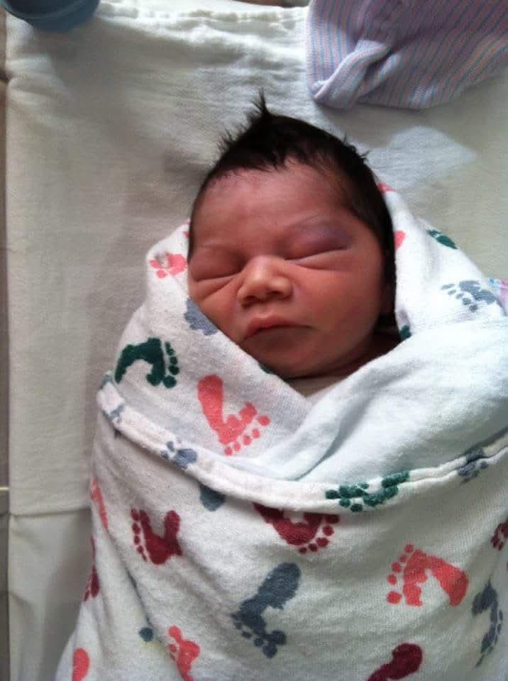 A baby wrapped in a blanket