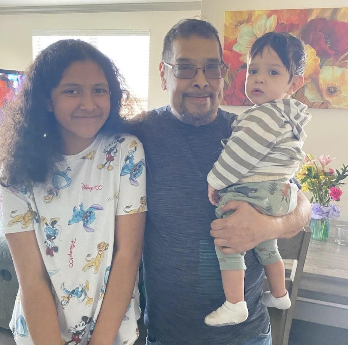 A man holding a baby and a woman
