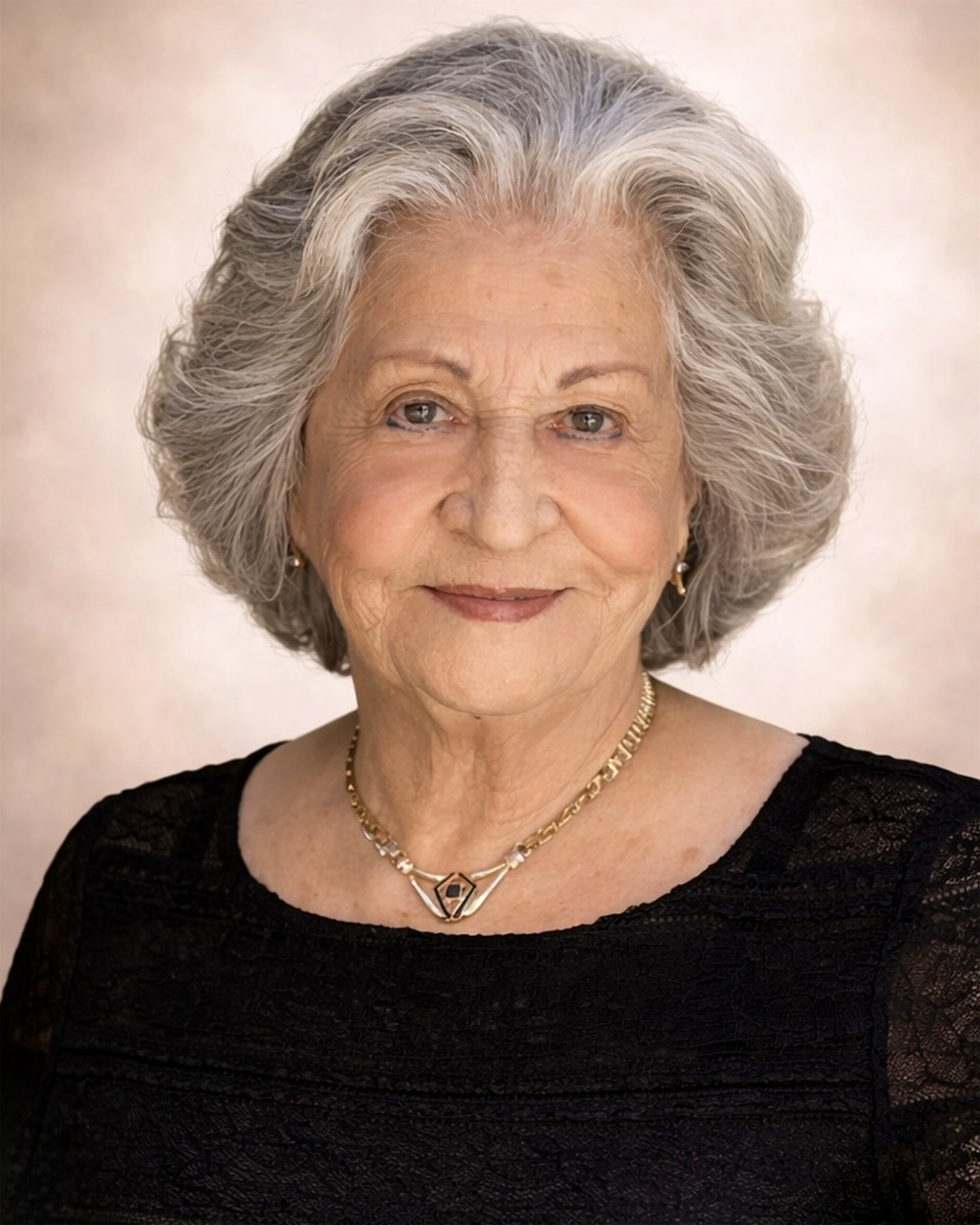 A woman with grey hair and a black dress