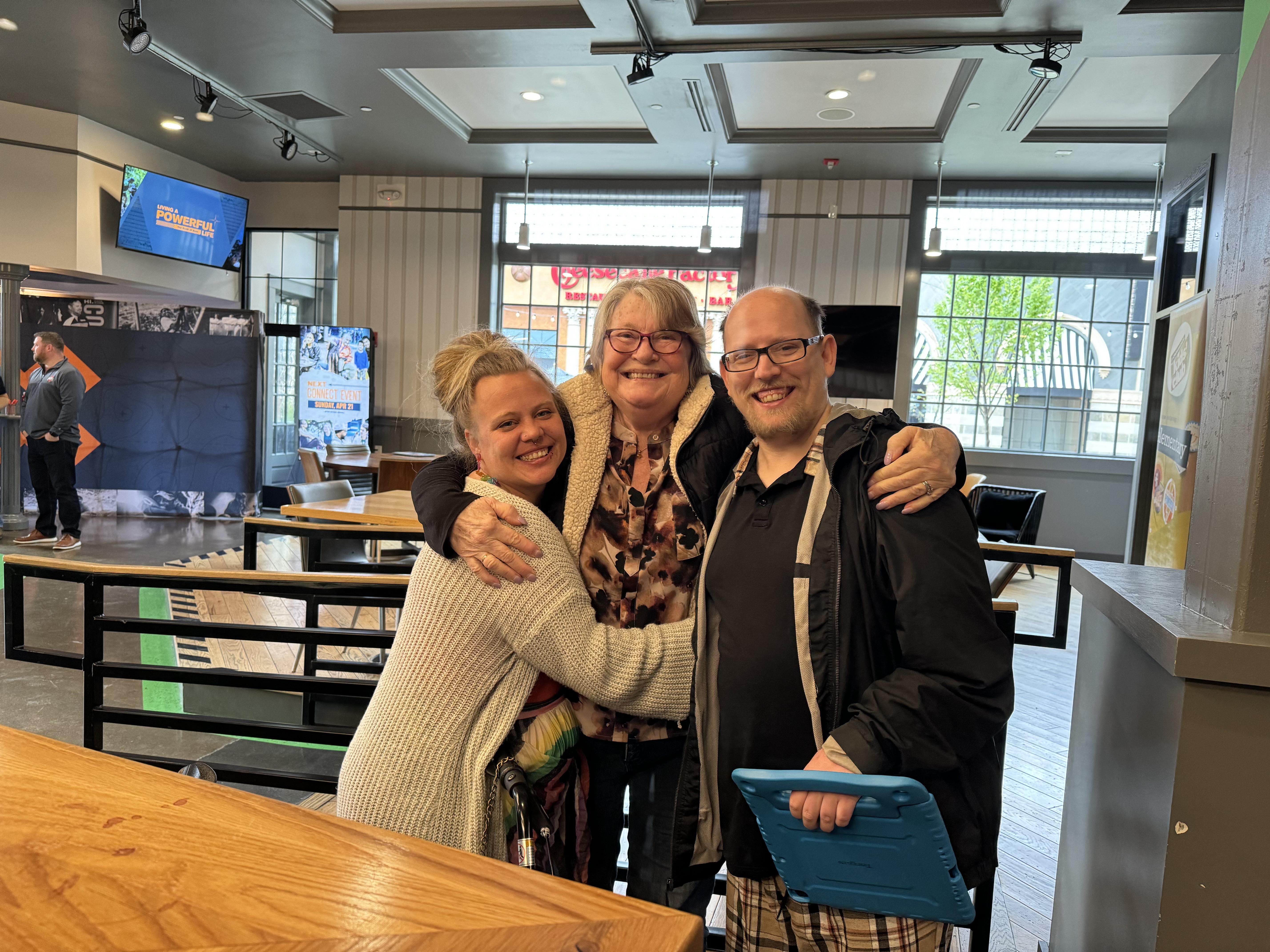 A group of people hugging each other