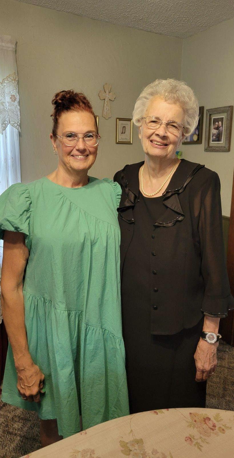 Two women standing together smiling