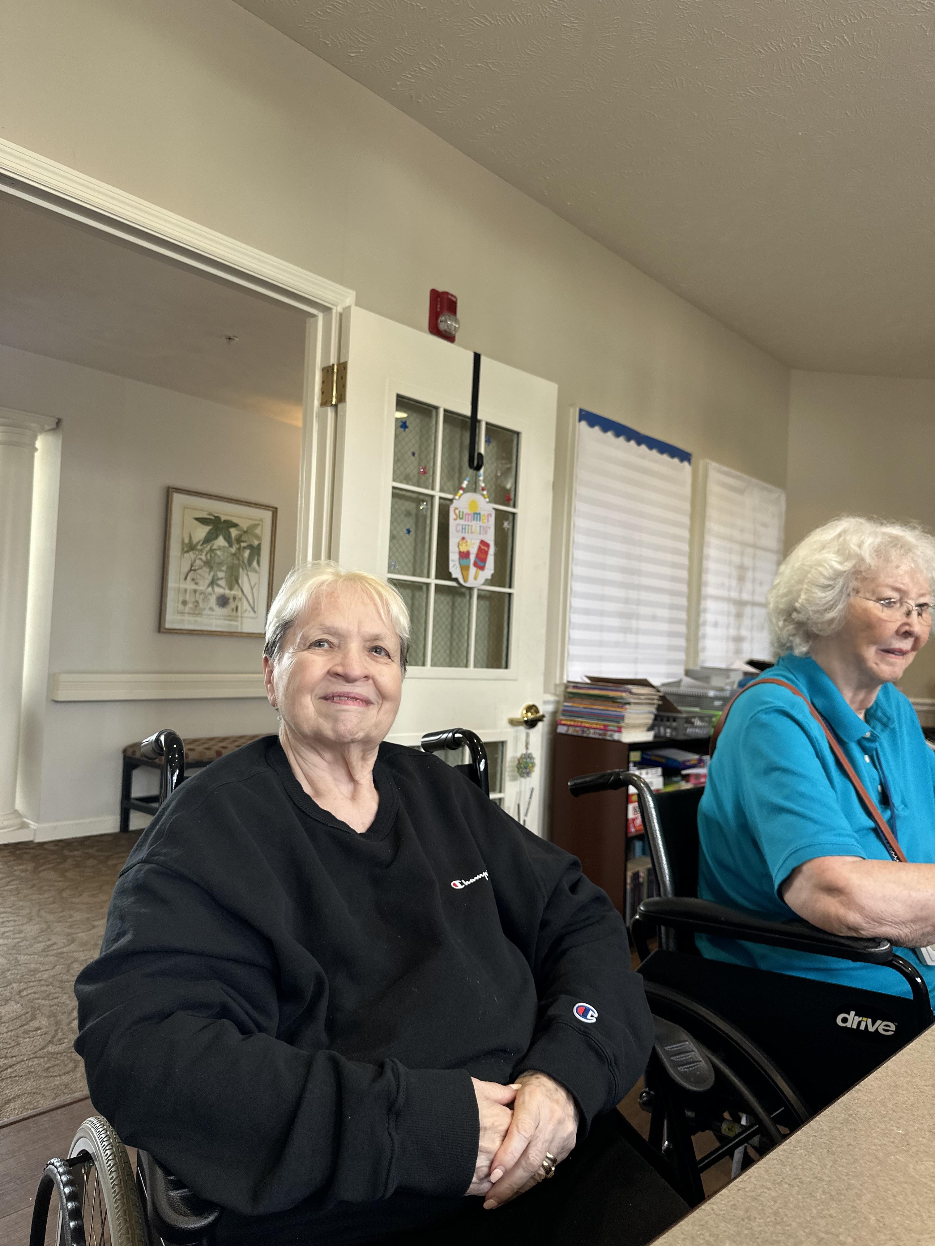 Two women sitting in wheelchairs