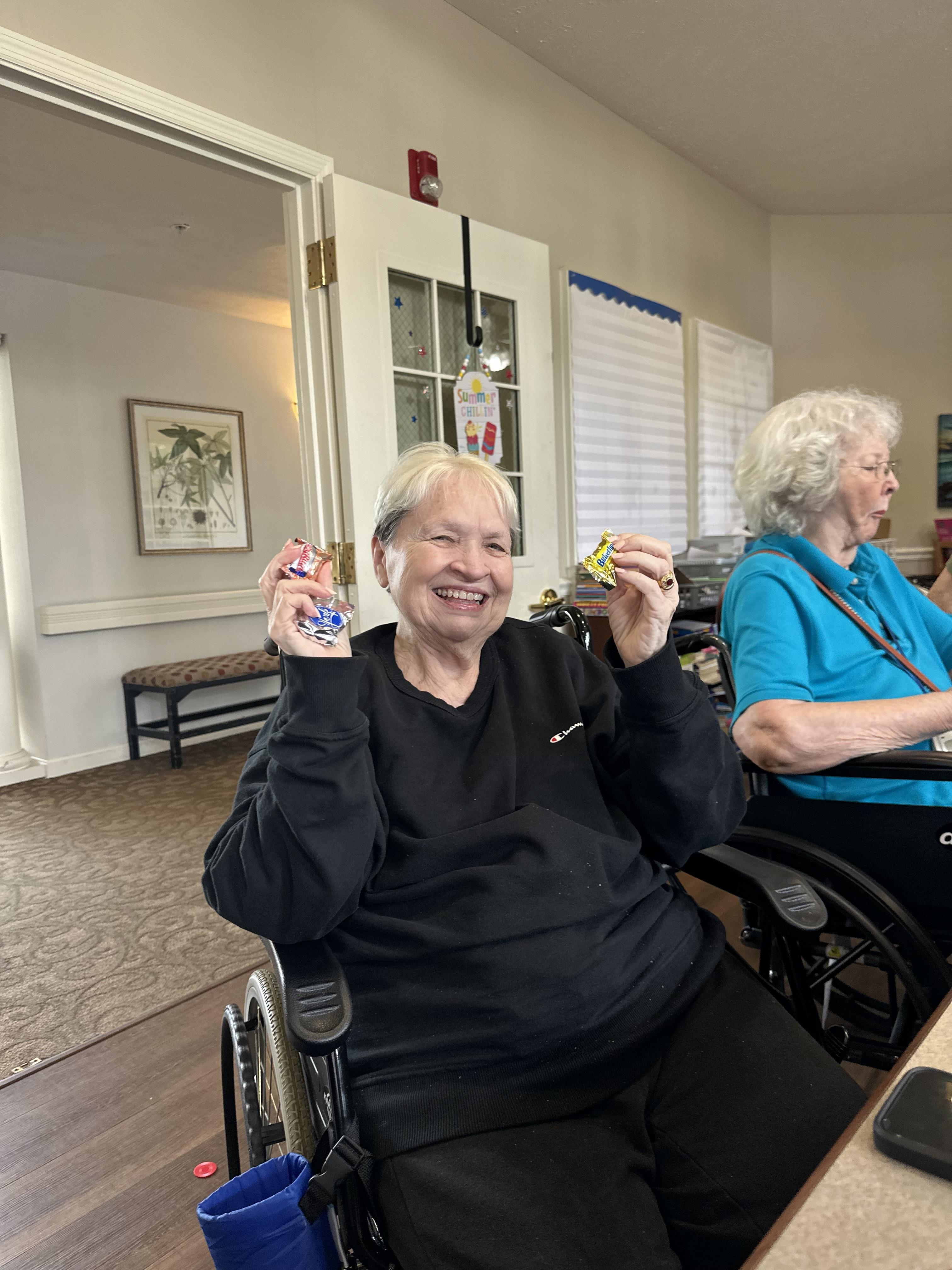 A woman in a wheelchair holding candy