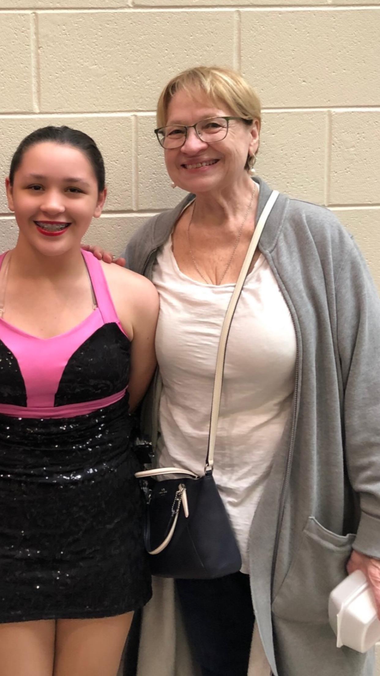 A woman and a girl posing for a picture