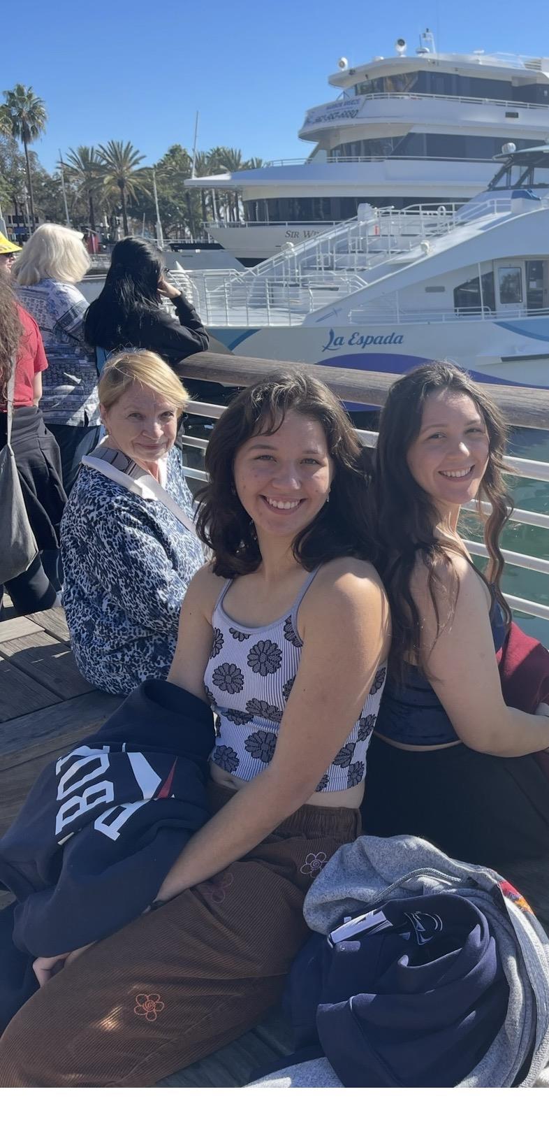 A group of women sitting on a dock