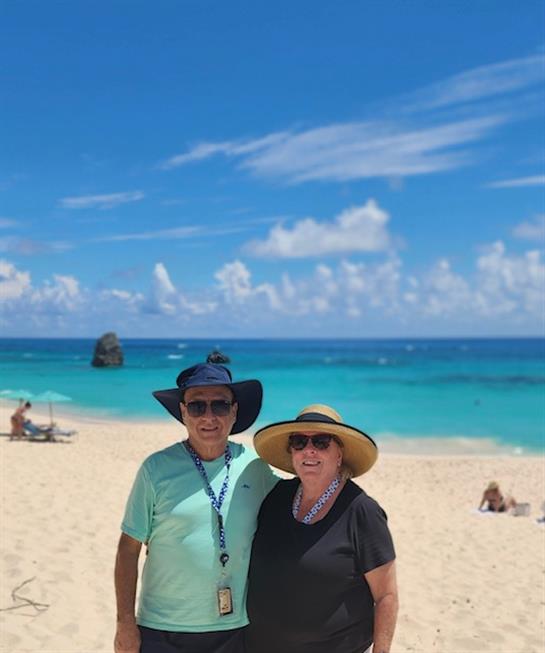 A man and woman standing on a beach