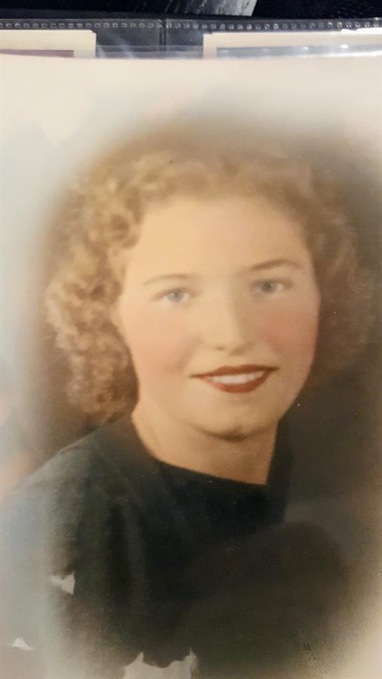 A woman with curly hair smiling