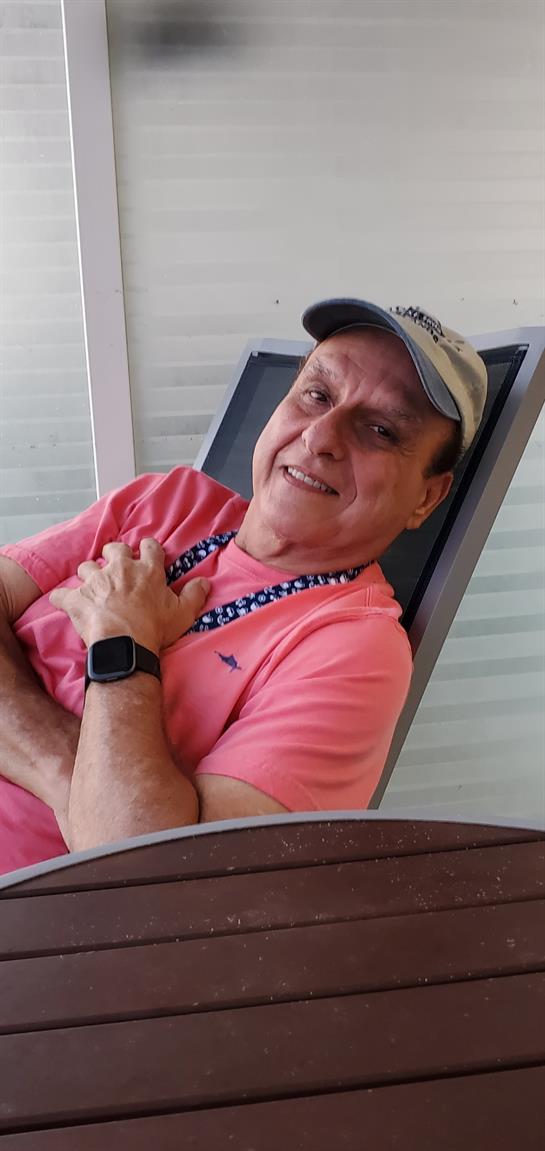 A man in a pink shirt