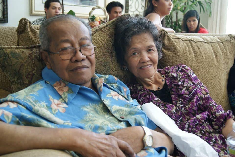 A man and woman sitting on a couch