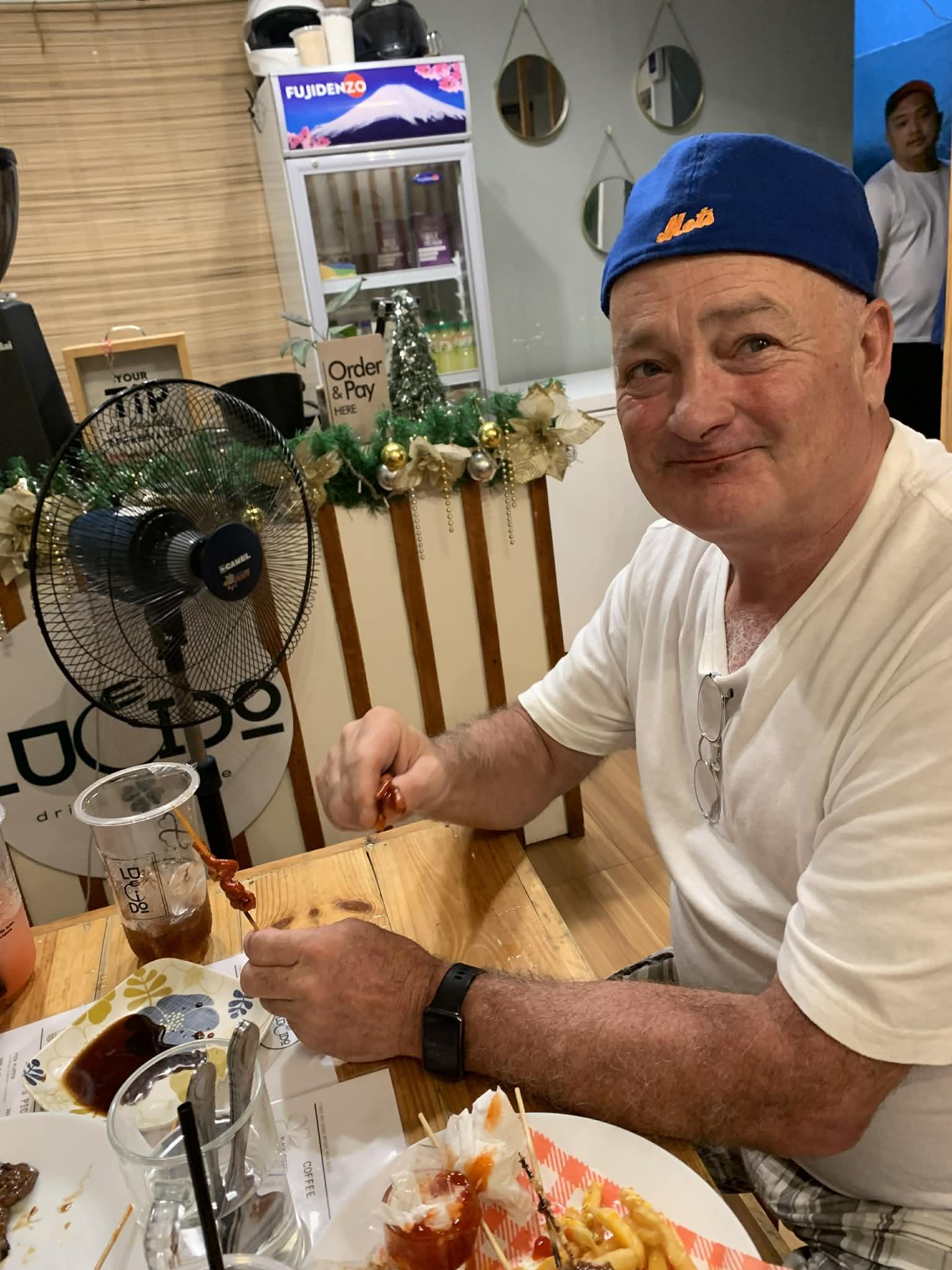 A man sitting at a table eating food