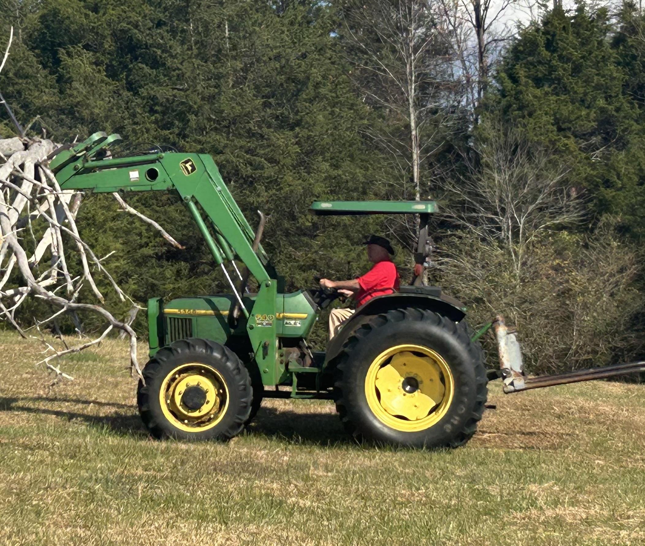 A man driving a tractor