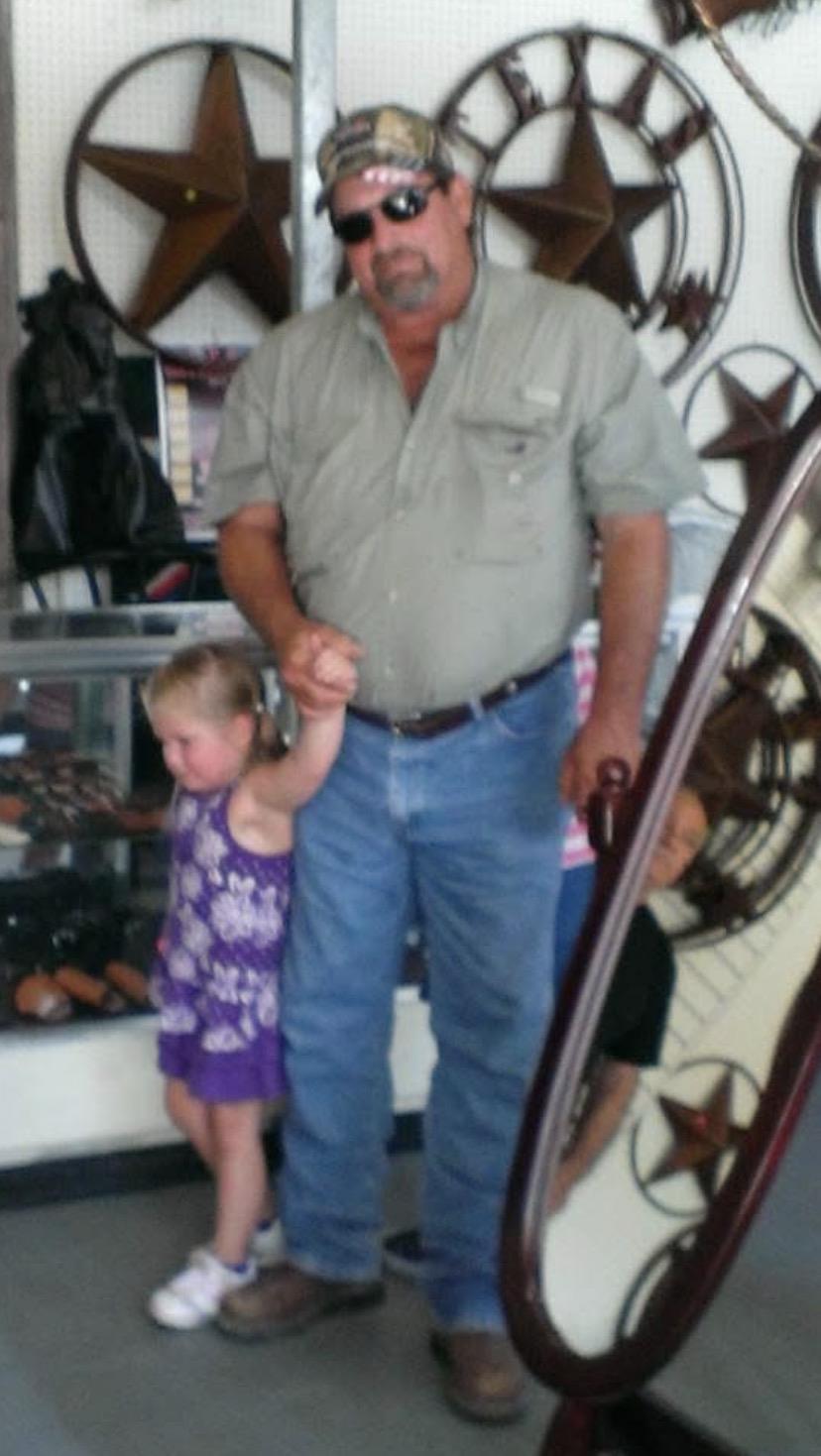 A man and a little girl standing in front of a glass case
