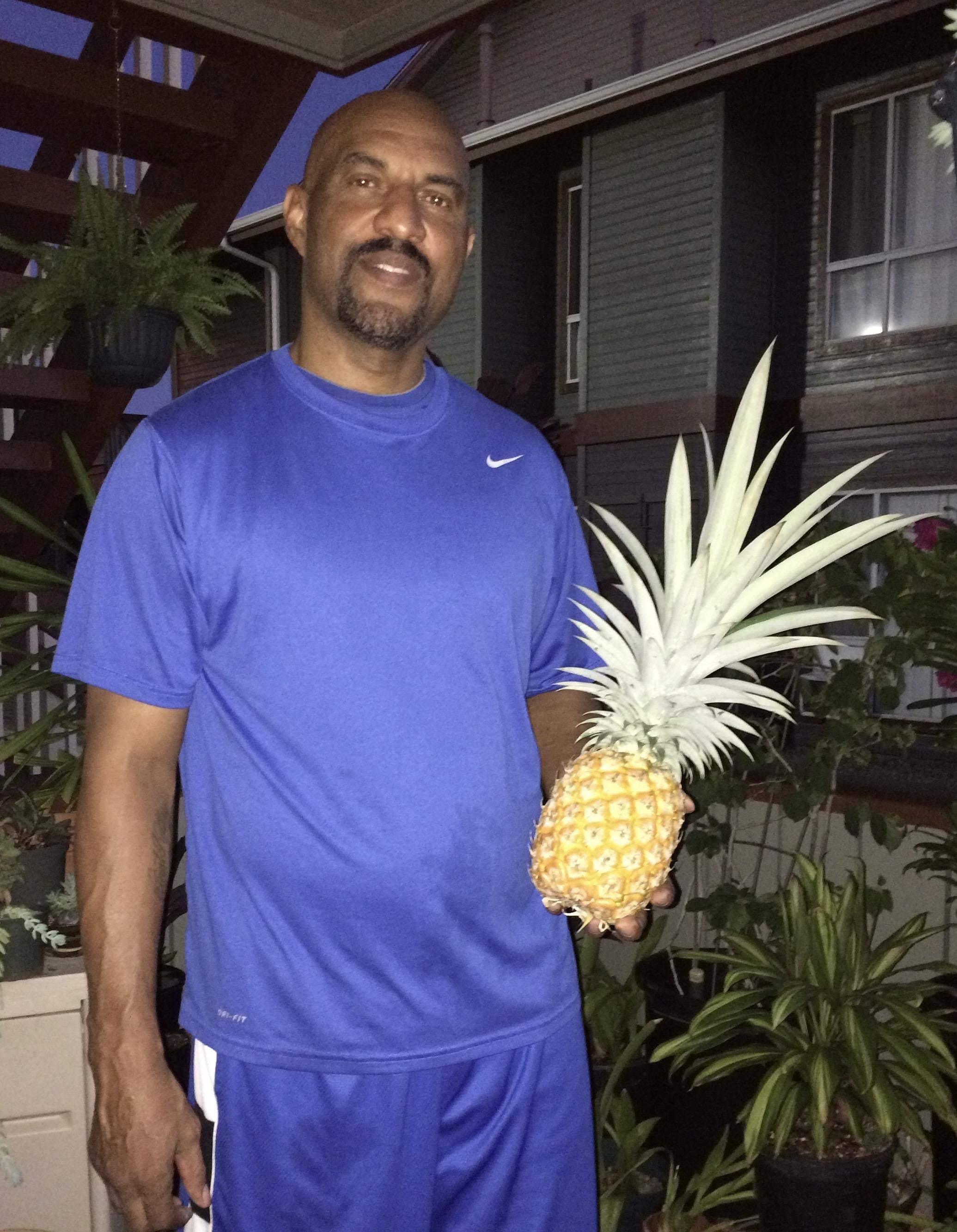 A man holding a pineapple