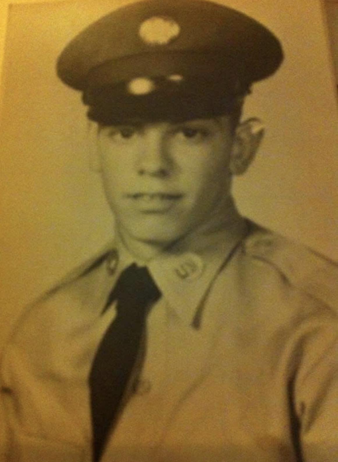 A man in uniform and tie