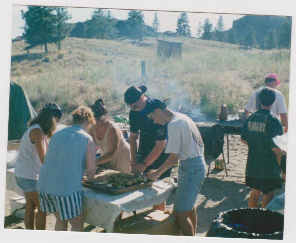 A group of people outside cooking food