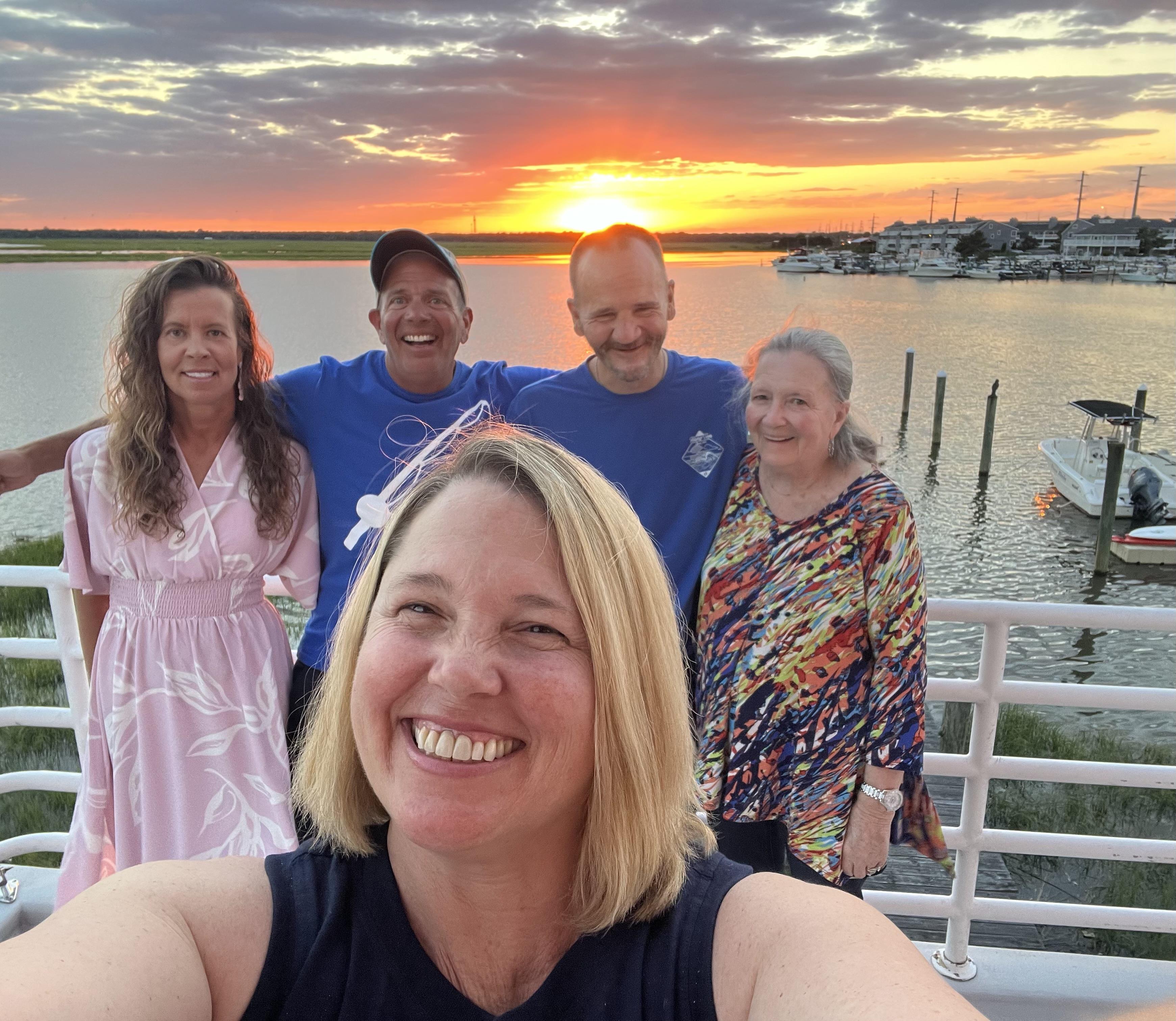 A group of people standing on a boat