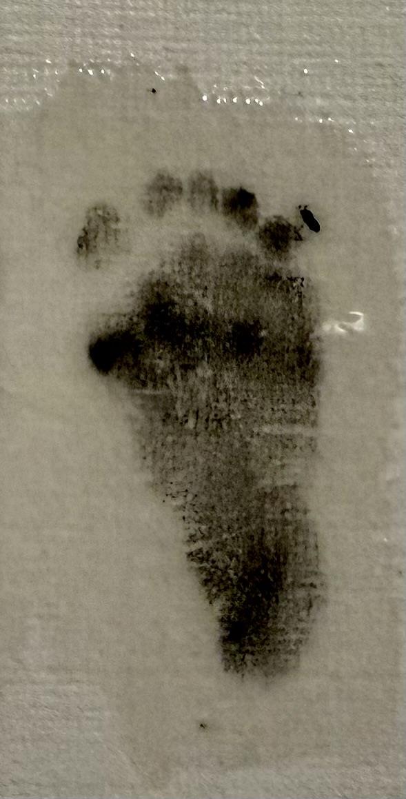 A black foot print on a white surface