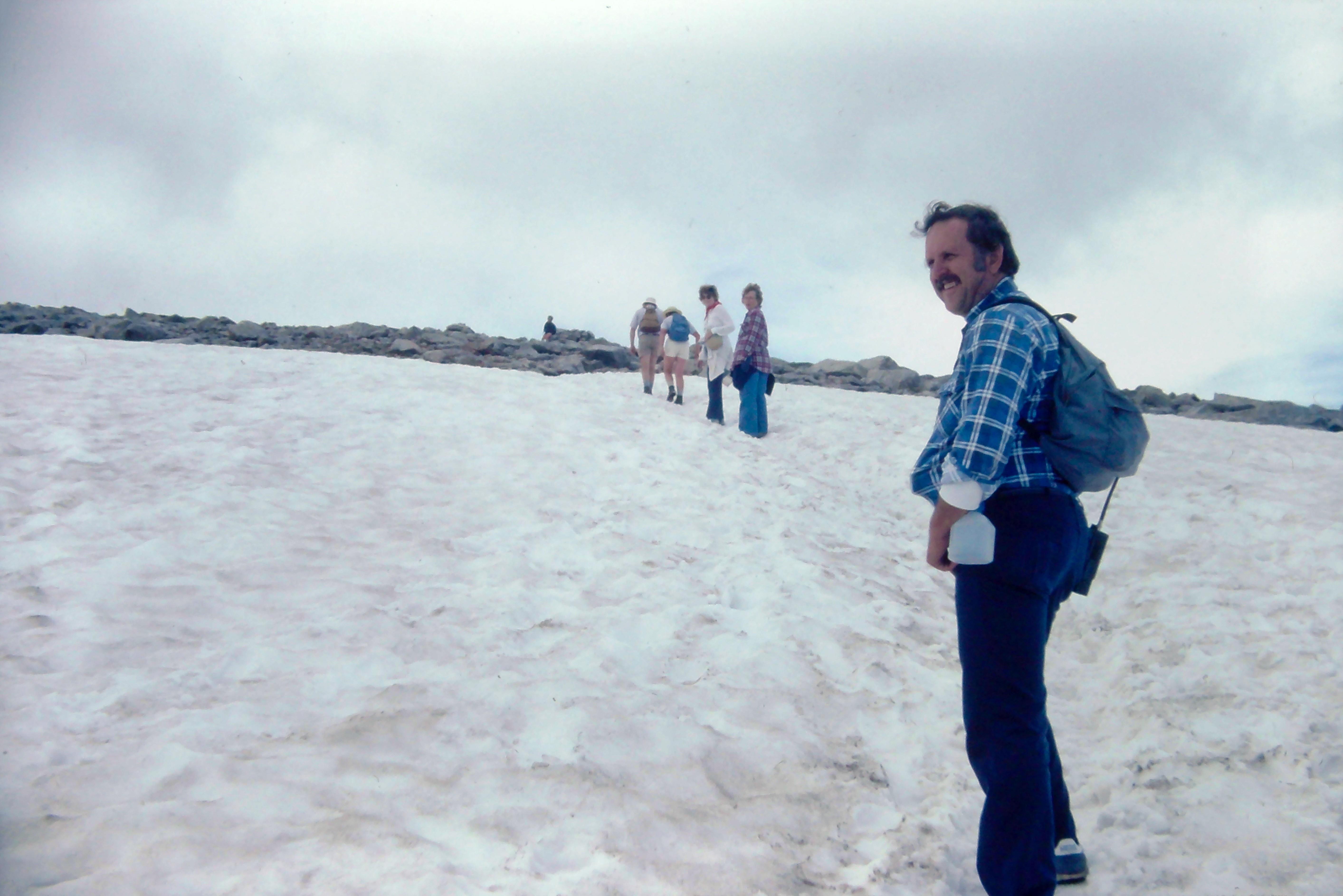 A man standing on a snowy hill