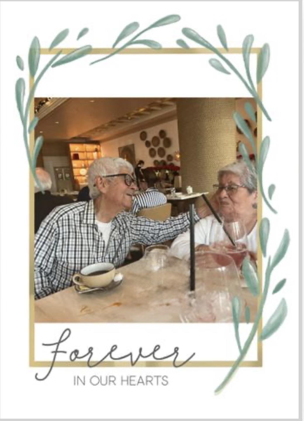 A man and woman drinking from a glass