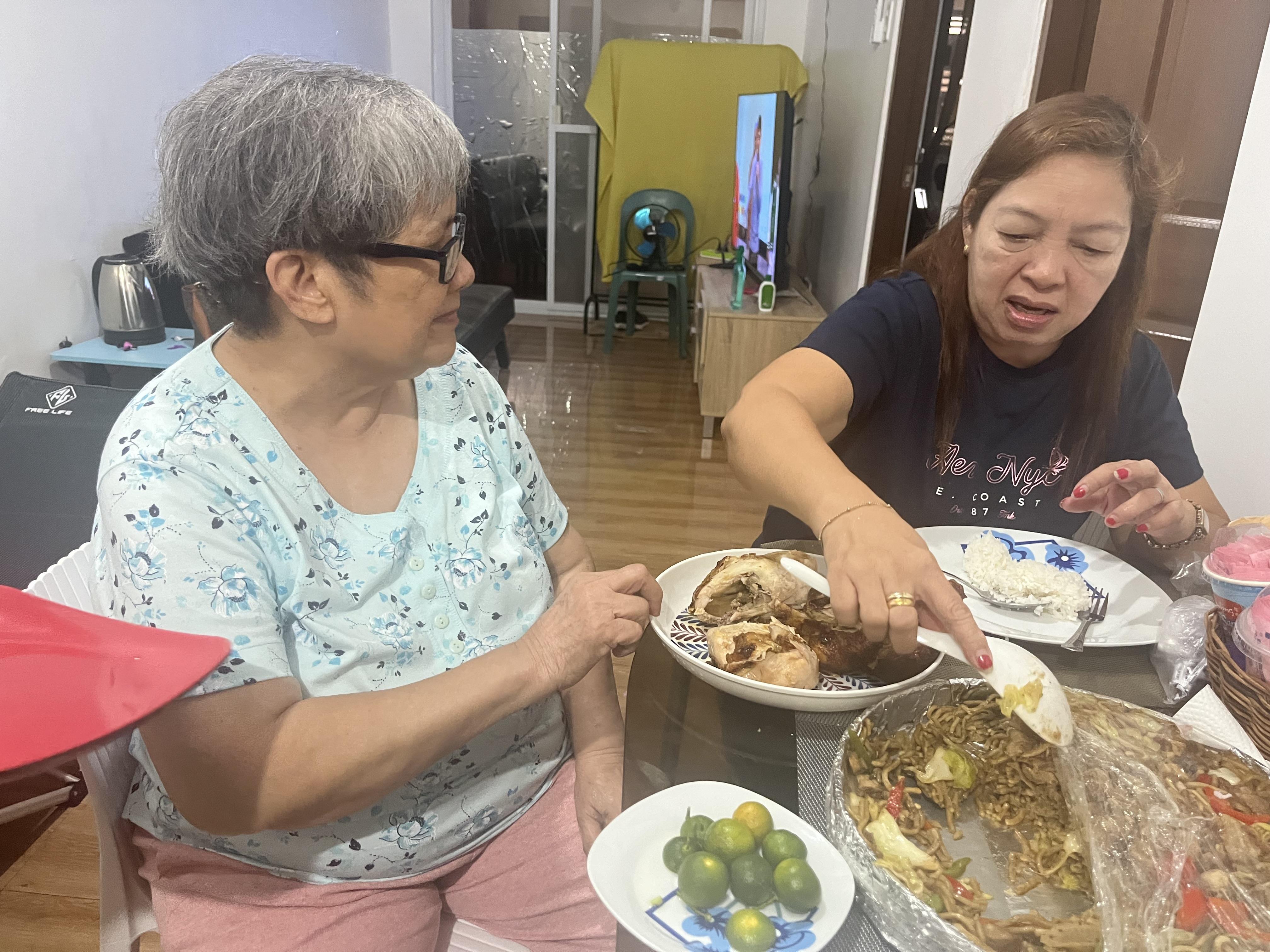 A group of women sitting at a table eating food