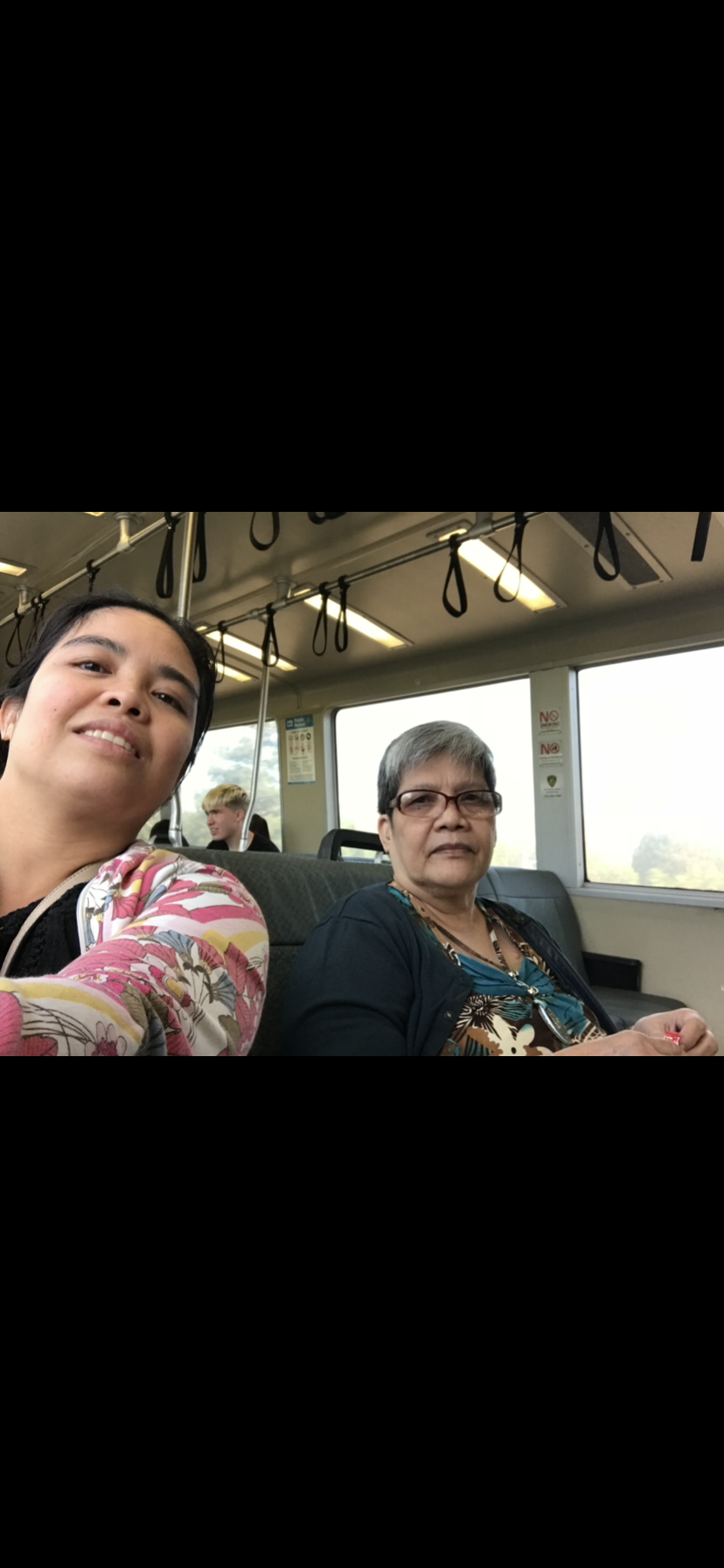 Two women sitting on a bus