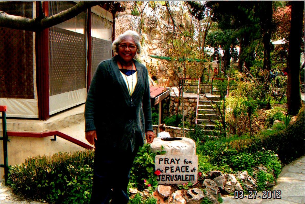A woman standing next to a sign