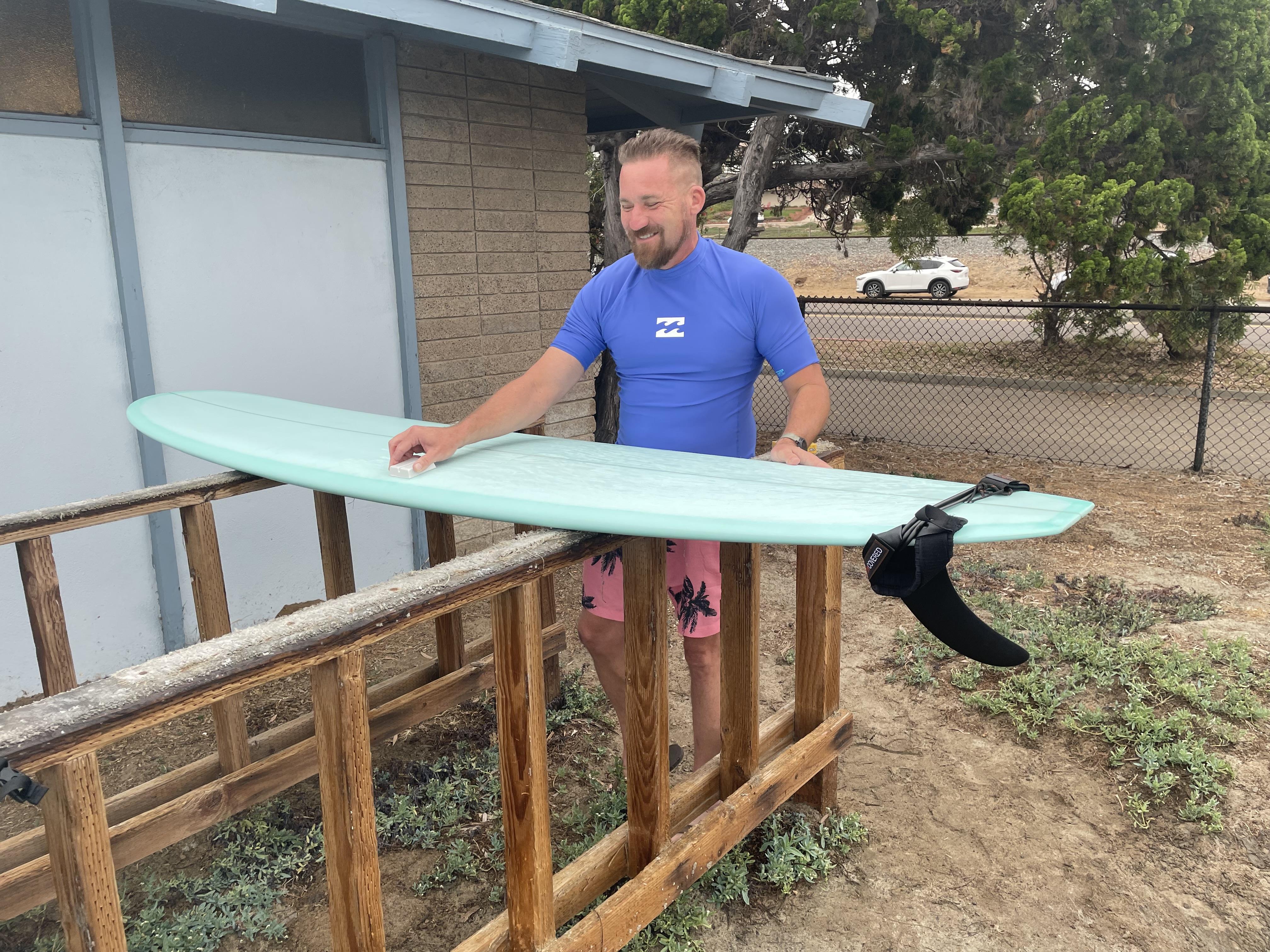 A man holding a surfboard