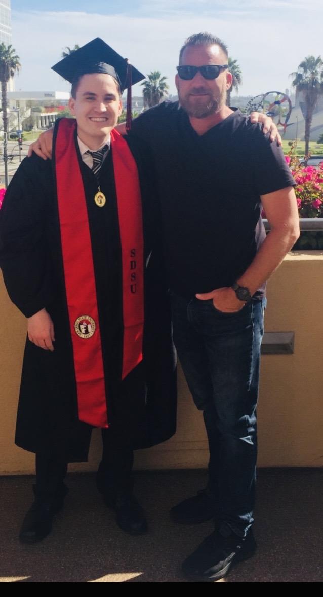 A man in a graduation gown and a man in a black robe