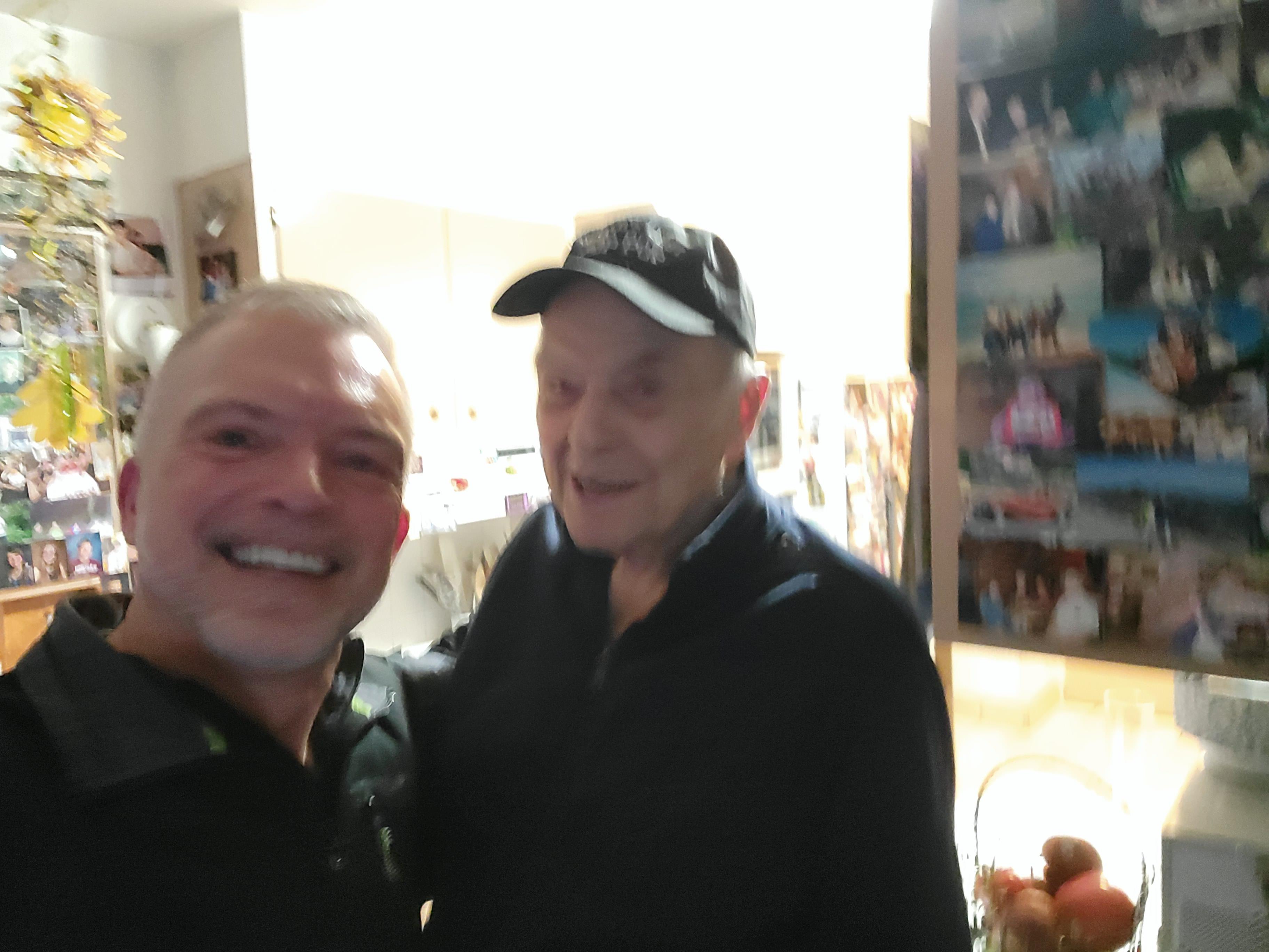 Two men smiling at the camera