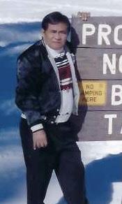 A man standing in front of a sign